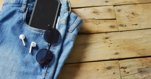 Close Jeans Smartphone Earphones Sunglasses Wooden Background Copy Space Denim — Wideo stockowe