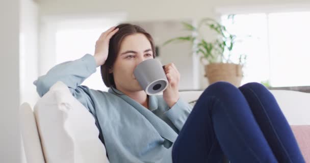 Happy Caucasian Woman Sitting Couch Drinking Coffee Spending Quality Time — Wideo stockowe
