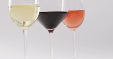 Diverse types of wines in glasses on white surface with copy space. Wine, alcohol, beverage and wine tasting concept.