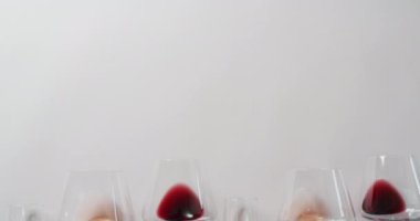 Glasses with diverse types of wines lying on grey surface with copy space. Wine, alcohol, beverage and wine tasting concept.