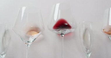 Glasses with diverse types of wines lying on grey surface with copy space. Wine, alcohol, beverage and wine tasting concept.