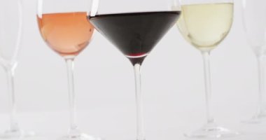 Diverse types of wines in glasses on white surface with copy space. Wine, alcohol, beverage and wine tasting concept.