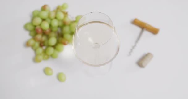 White Wine Glass Corkscrew Grapes Lying White Surface Copy Space — Wideo stockowe