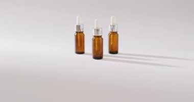Close up of dropper serum bottles on white background with copy space. Beauty products, cosmetics and skincare concept.