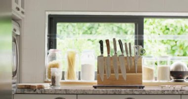 Empty house interior of kitchen with knives in row on table. House interior and furniture concept.