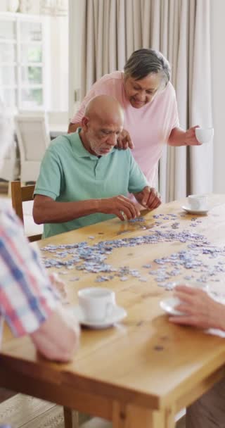 Vertical Video Senior Biracial Couple Doing Jigsaw Friends Living Room — ストック動画