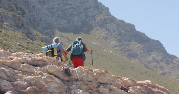 Senioren Paar Den Bergen Beim Wandern Mit Trekking Stöcken Zeitlupe — Stockvideo