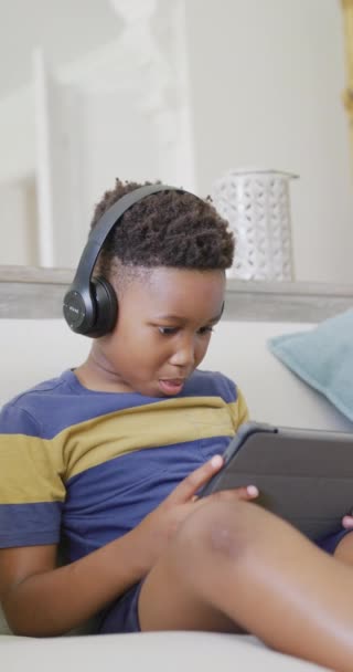 Vertical Video African American Boy Sitting Sofa Using Tablet Slow — Stock Video