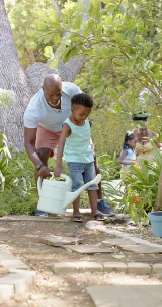 Lodret Video Glad Afrikansk Amerikansk Bedstefar Barnebarn Havearbejde Slowmotion Tilbringe – Stock-video