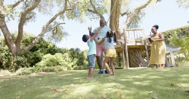 Glada Afrikanska Amerikanska Morföräldrar Med Barnbarn Som Spelar Fotboll Trädgården — Stockvideo