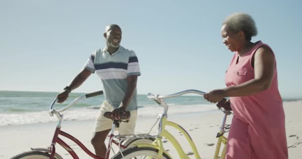 Happy Senior African American Couple Walking Bikes Beach Slow Motion — Stock Video