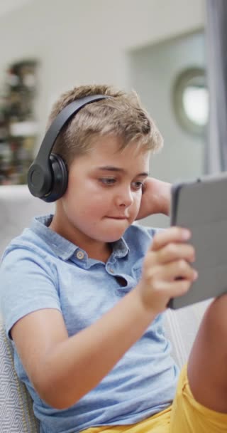Vertical Video Happy Caucasian Boy Lying Sofa Using Tablet Slow — Stock Video