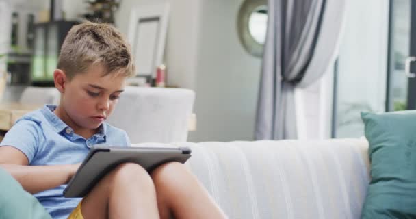 Happy Caucasian Boy Sitting Sofa Using Tablet Copy Space Slow — Stock Video