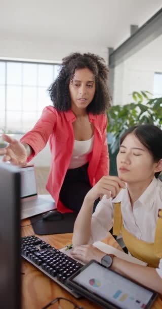 コンピュータを使用して幸せな多様なビジネス女性の垂直ビデオやオフィスでの仕事を議論 ビジネス テクノロジー チームワーク — ストック動画