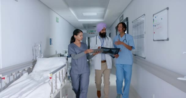 Zróżnicowane Lekarze Pielęgniarki Pomocą Tabletu Chodzenie Korytarzem Szpitalu Zwolnionym Tempie — Wideo stockowe