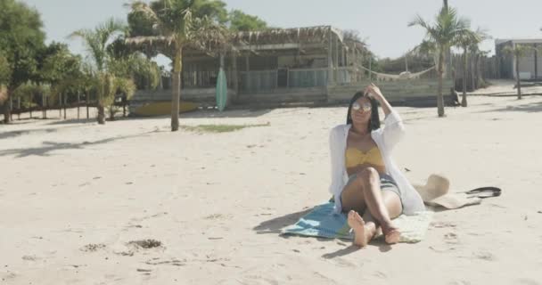 Glad Latinamerikansk Kvinna Solglasögon Sittande Stranden Solen Kopiera Utrymme Slow — Stockvideo