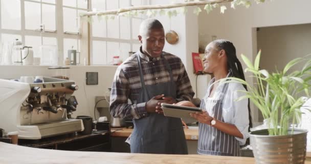 African American Male Female Baristas Using Tablet Talking Coffee Shop — Stock Video