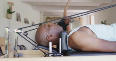 Pilates sınıfında, değişmeden, ağır çekimde bayan koçla gerinen farklı yaşlılara odaklanmış. Egzersiz, emeklilik ve sağlıklı bir yaşam tarzı..