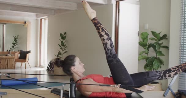 Fit Senior Caucasian Woman Stretching Reformer Pilates Studio Unaltered Slow — Stock Video