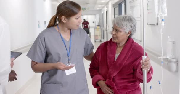 Heureuse Infirmière Diversifiée Parlant Une Patiente Âgée Avec Goutte Goutte — Video