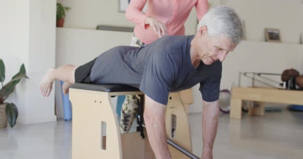 Focused Senior Caucasian Man Exercising Female Pilates Coach Unaltered Slow — Stock Video