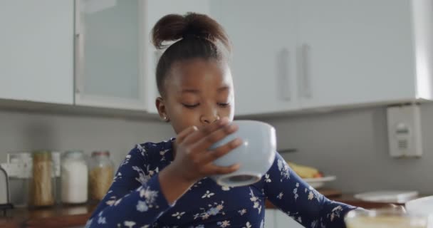 African American Girl Sitting Countertop Eating Breakfast Kitchen Slow Motion — Stock Video