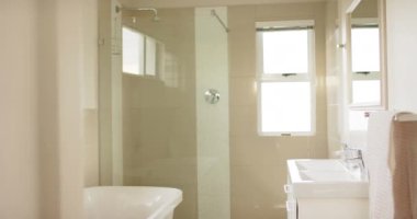 Duş kabini, banyo küveti ve lavabosu olan modern banyo manzarası, yavaş çekim. İç tasarım ve ev hayatı.