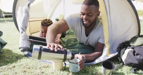 Африканский Американец Отец Сын Лежат Палатке Используют Планшет Саду Замедленной — стоковое видео