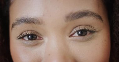 Portrait close up of happy biracial woman smiling to camera, in slow motion.