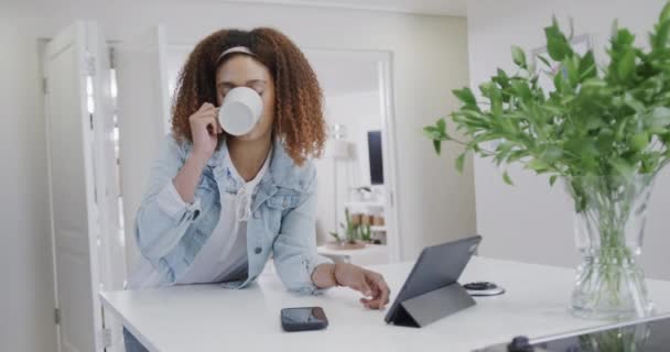 Mulher Biracial Feliz Usando Tablet Beber Café Cozinha Câmera Lenta — Vídeo de Stock