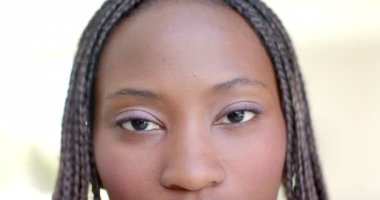 Saçları örgülü ve ağır çekimde gülümseyen mutlu Afro-Amerikan kadının portresi. Mutluluk, ev hayatı ve yaşam tarzı, değişmedi..