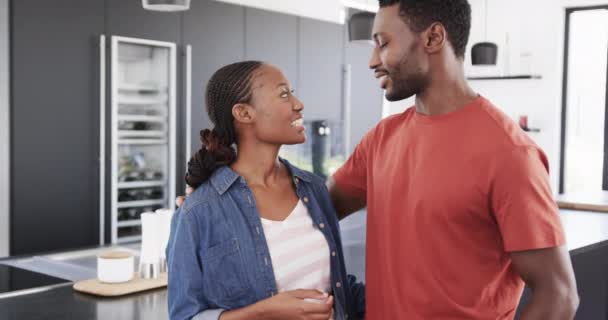 幸せなアフリカ系アメリカ人のカップルの話や台所で スローモーションを受け入れる ライフスタイル 幸福と国内生活 変わらない — ストック動画