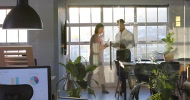 Belge ve tabletle çeşitli erkek ve kadın meslektaşlar toplantı odasında tartışıyor, ağır çekimde. İş, takım çalışması, iletişim, ofis ve iş.