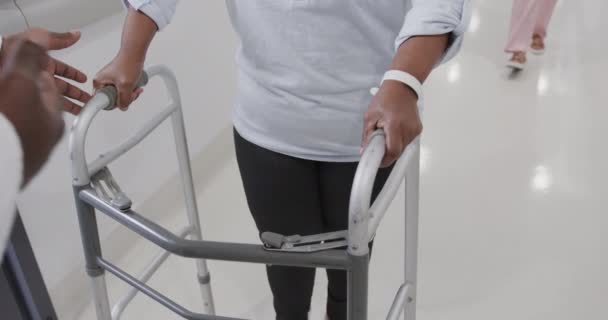 Midsection Diverse Male Doctor Helping Senior Female Patient Use Walking — Stock Video