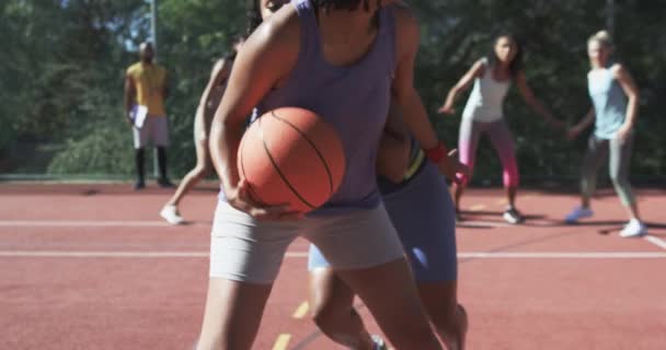 Happy Diverse Female Basketball Team Training Male Coach Sunny Court — Stock Video