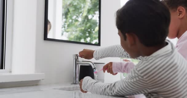 Mutlu Çift Irklı Erkek Kız Kardeşler Güneşli Banyoda Dişlerini Fırçalarken — Stok video