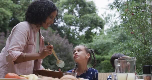 Szczęśliwa Dwurasowa Matka Syn Córka Jedzą Obiad Przy Stole Ogrodzie — Wideo stockowe