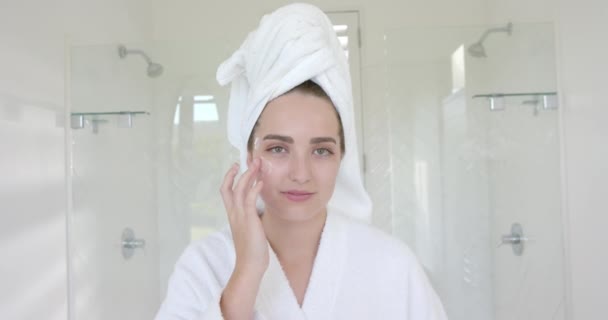 Portret Białej Kobiety Ręcznikiem Głowie Nakładającym Krem Twarz Łazience Zwolnionym — Wideo stockowe