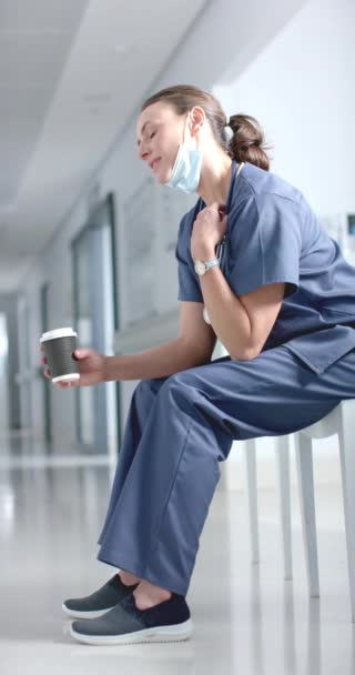 Vertical Video Caucasian Female Doctor Drinking Coffee Corridor Hospital Slow — Stock Video