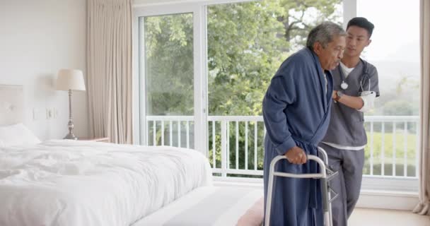 Zróżnicowany Męski Lekarz Pomaga Starszemu Pacjentowi Używać Ruchomej Ramy Domu — Wideo stockowe