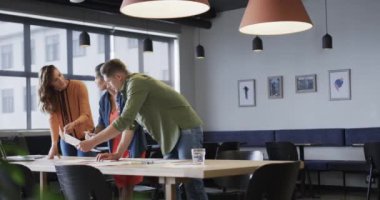 Çeşitli erkek ve kadın meslektaşlar gündelik ofis toplantılarında dizüstü bilgisayar ve notlar kullanarak tartışıyorlar. Günlük ofis, takım çalışması, iş, yaşam tarzı ve çalışma, değiştirilmemiş.