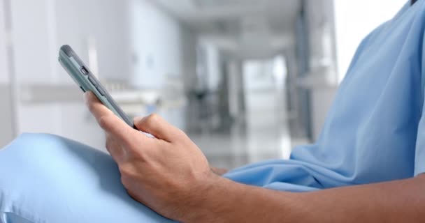 Środkowa Część Dwurasowego Lekarza Używającego Smartfona Korytarzu Zwolnione Tempo Szpital — Wideo stockowe