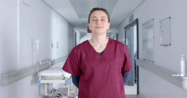 Portrait Caucasian Female Doctor Wearing Scrubs Smiling Corridor Slow Motion — Stock Video