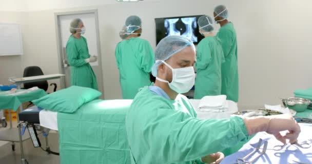 Divers Chirurgiens Portant Des Blouses Chirurgicales Regardant Des Radiographies Salle — Video
