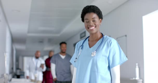 Portrait Happy African American Female Doctor Wearing Scrubs Smiling Corridor — Stock Video
