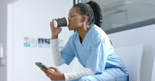 African American Female Doctor Using Smartphone Drinking Coffee Corridor Slow — Stock Video