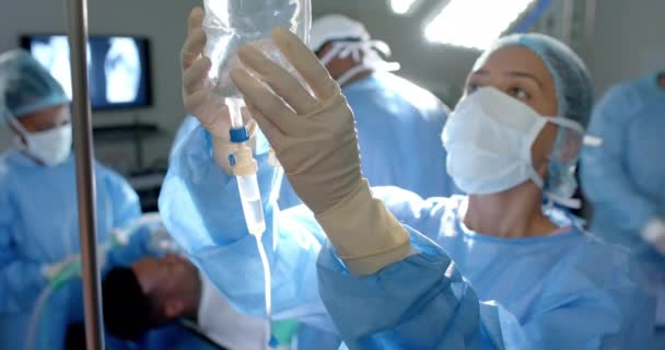 Cirurgiões Diversos Vestindo Batas Cirúrgicas Aplicando Gotejamento Sala Operações Câmera — Vídeo de Stock
