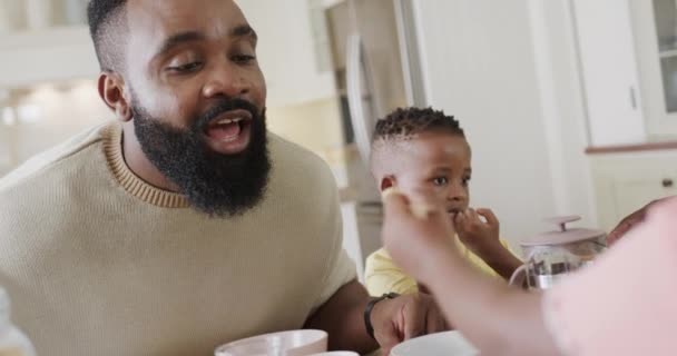 快乐的非洲裔美国父亲 带着儿子和女儿在餐厅吃饭 动作缓慢 生活方式和家庭生活 — 图库视频影像