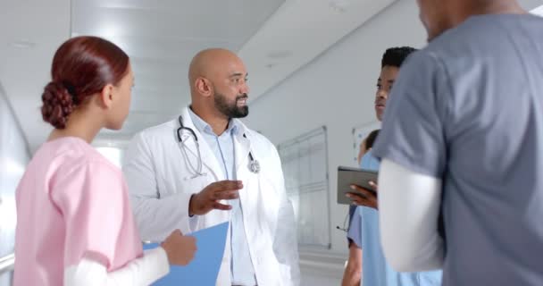 Diverse Doctors Discussing Work Using Tablet Corridor Hospital Slow Motion — Stock Video
