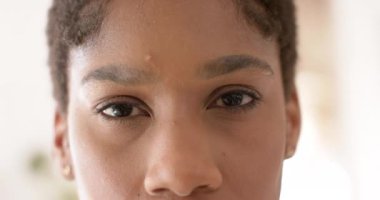 Portrait of happy african american casual businesswoman in creative office in slow motion. Business and work, unaltered.